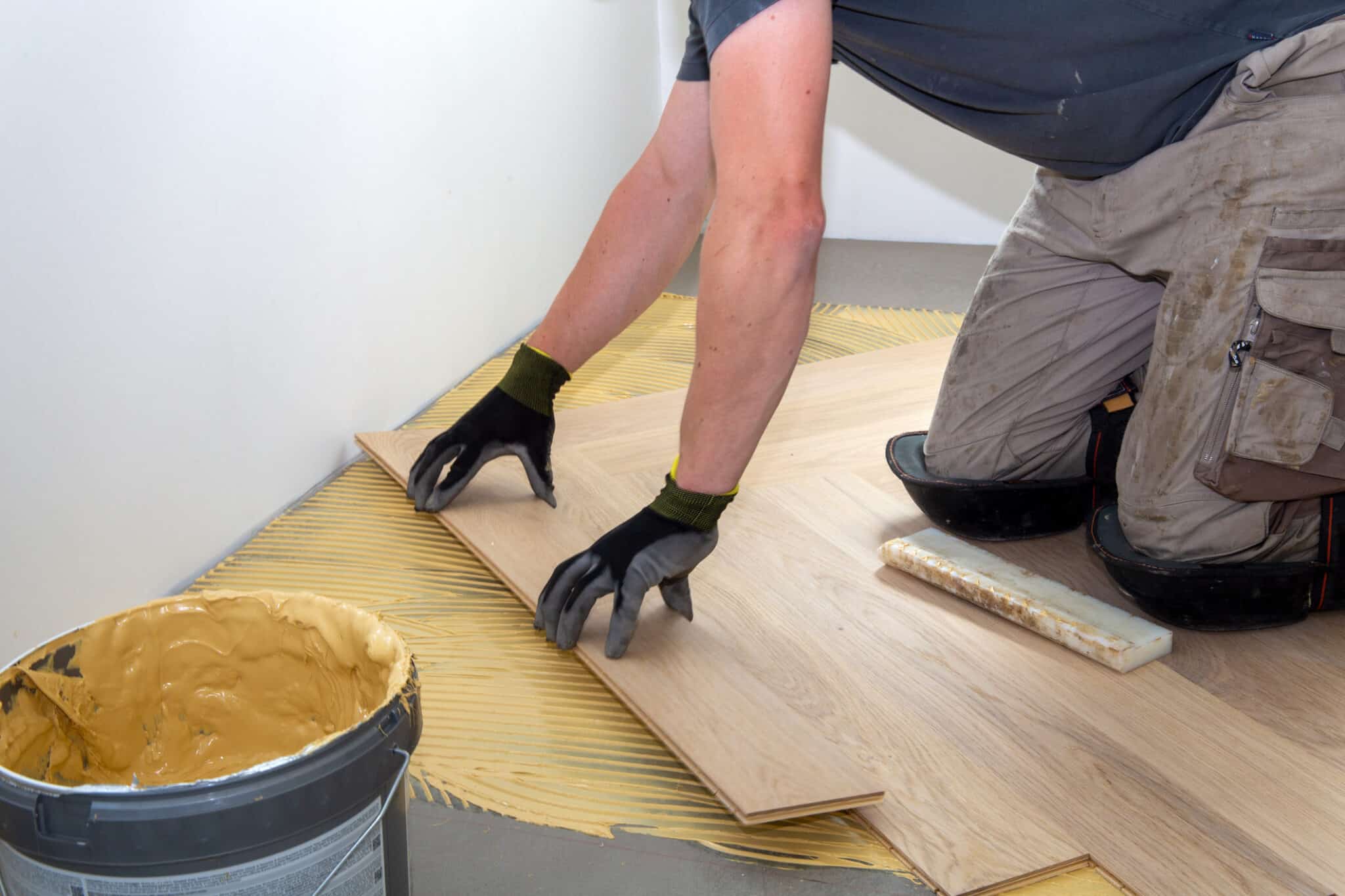 Craftsman laying herringbone parquet flooring professionally