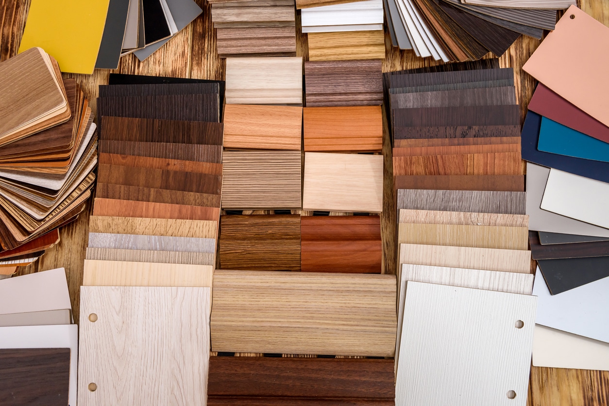 Wooden samplers for renovation on wooden table. Colorful pieces of wood and plywood close up