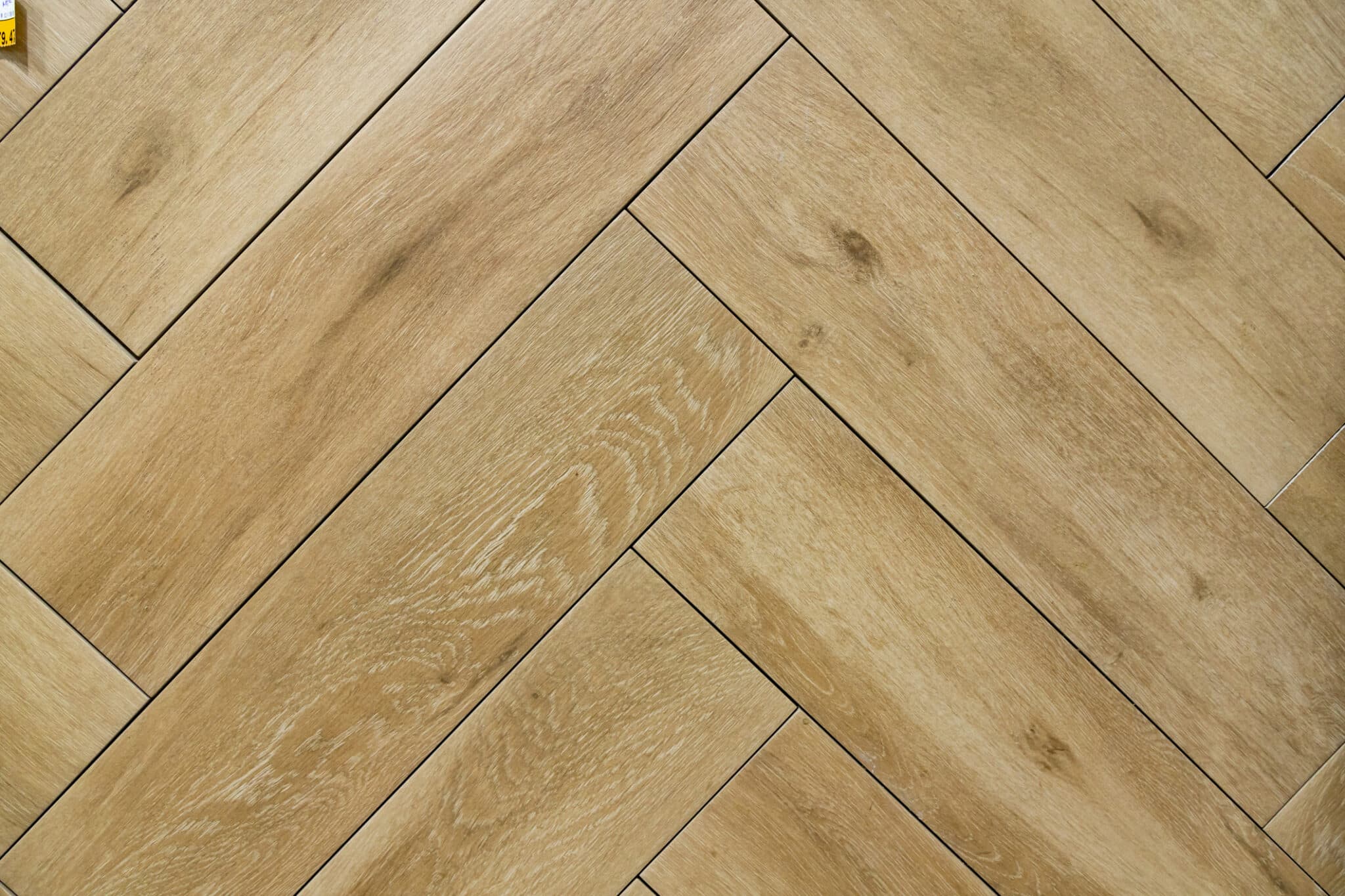 Beige wood texture tiles on the floor, herringbone geometric pattern