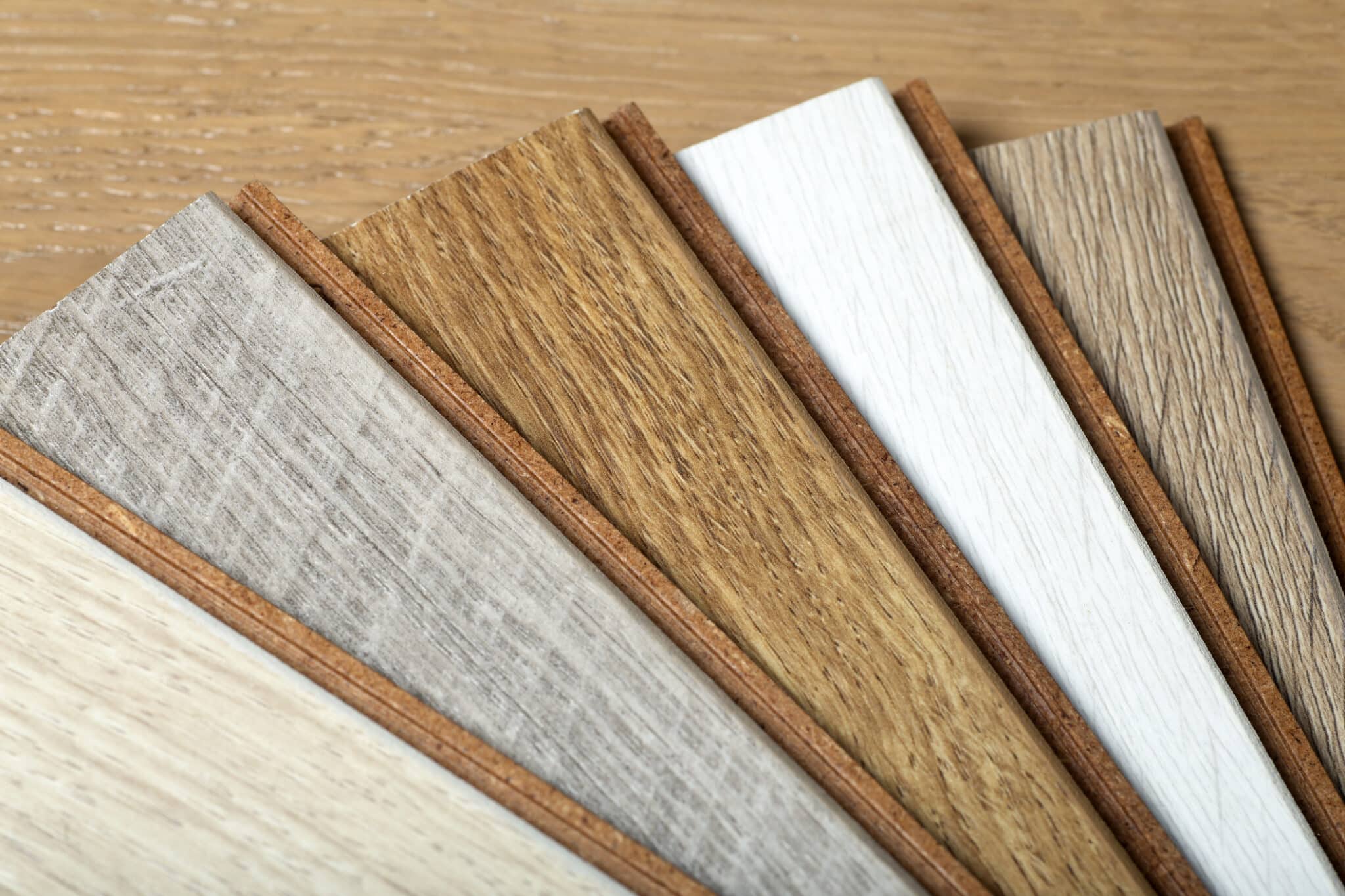 Laminate background. Samples of laminate or parquet with a pattern and wood texture for flooring and interior design. Production of wooden floors.